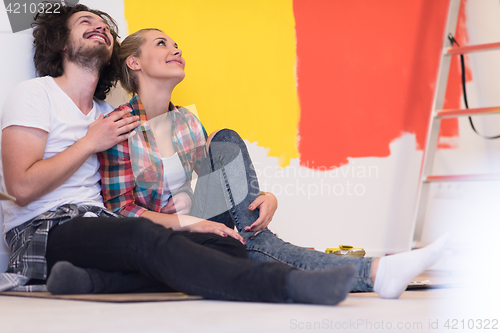 Image of Happy young couple relaxing after painting