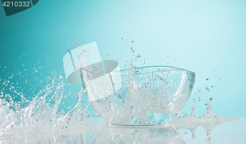 Image of The water splashing to glass bowl on white background