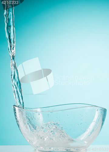 Image of The water splashing to glass bowl on white background