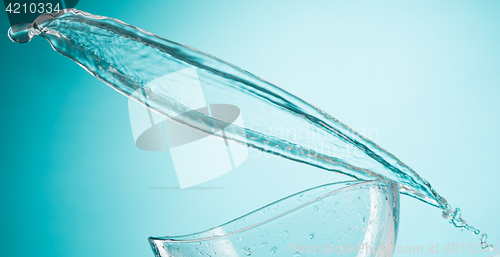 Image of The water splashing to glass bowl on white background