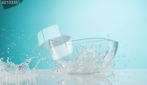 Image of The water splashing to glass bowl on white background