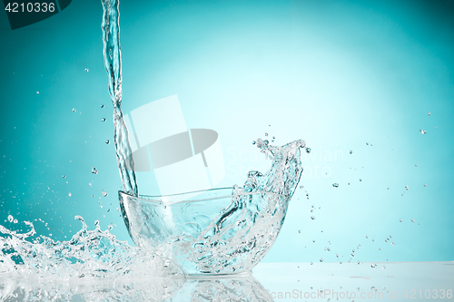 Image of The water splashing to glass bowl on white background