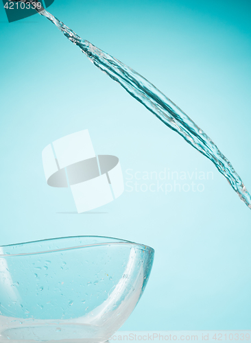 Image of The water splashing to glass bowl on white background