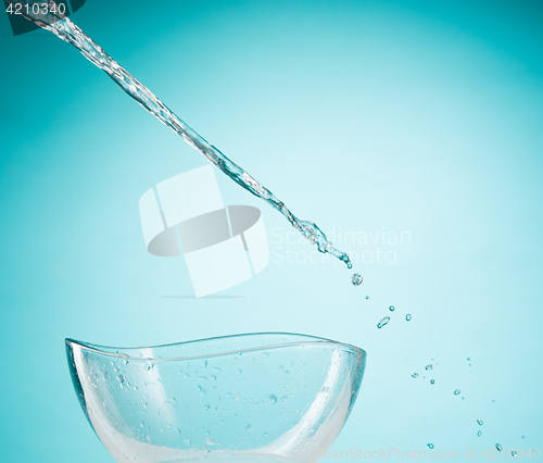 Image of The water splashing to glass bowl on white background