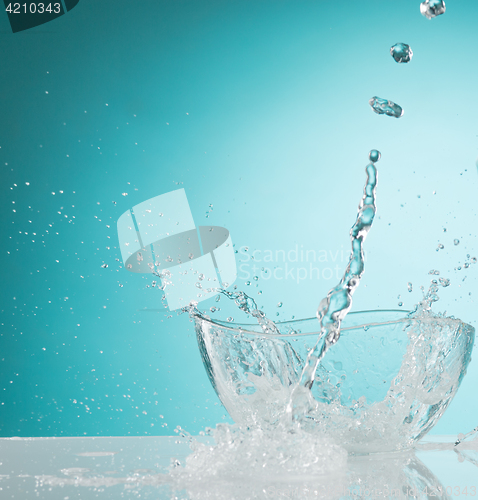 Image of The water splashing to glass bowl on white background