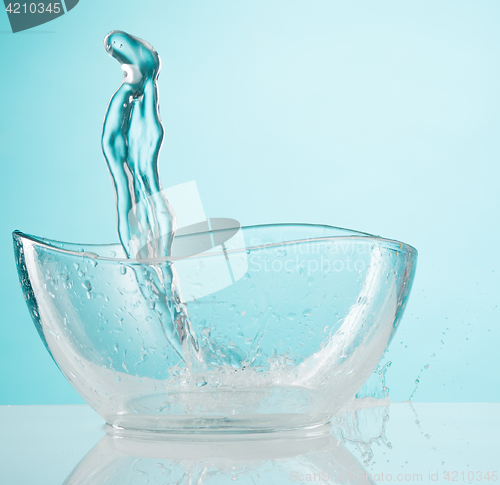 Image of The water splashing to glass bowl on white background