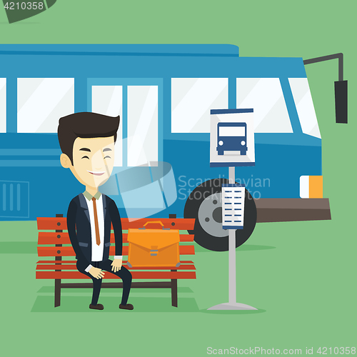 Image of Business man waiting at the bus stop.