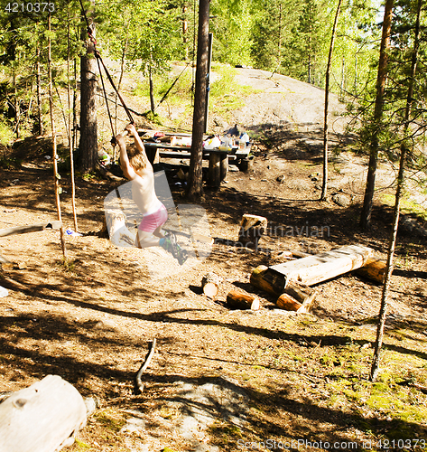 Image of little cute boy jumping with bungee in forest, training with dad