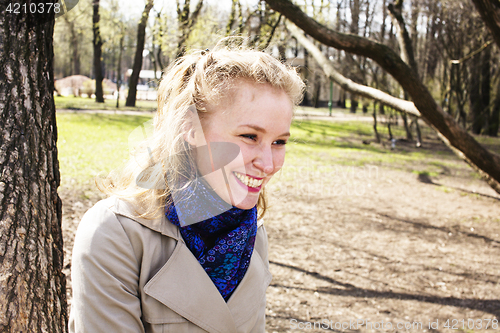 Image of young pretty blonde girl engoing spring nature in park, lifestyle epople concept