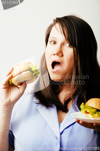 Image of fat white woman having choice between hamburger and salad close 