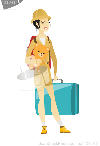 Image of Woman traveling with old suitcase and teddy bear.