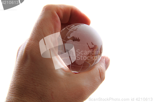 Image of glass earth globe in human hand