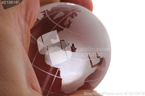 Image of glass earth globe in human hand