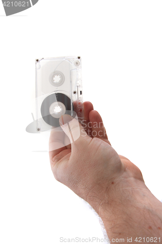 Image of audio cassette in human hand