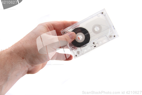 Image of audio cassette in human hand