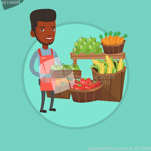 Image of Supermarket worker with box full of apples.