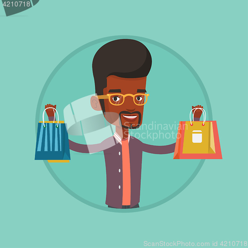 Image of Happy man holding shopping bags.