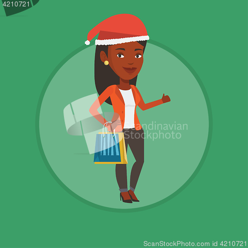 Image of Woman in santa hat shopping for christmas gifts.