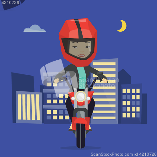 Image of Woman riding motorcycle at night.