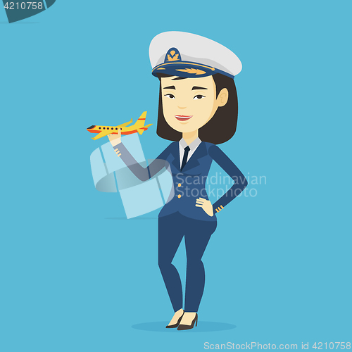 Image of Cheerful airline pilot with model airplane.