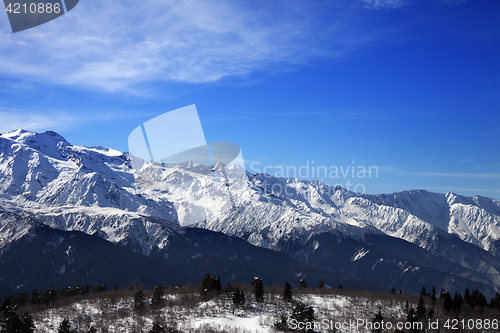Image of Sunlight snow mountains and blue sky with clouds in winter day