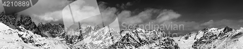 Image of Black and white large panoramic view on snow mountains in haze a