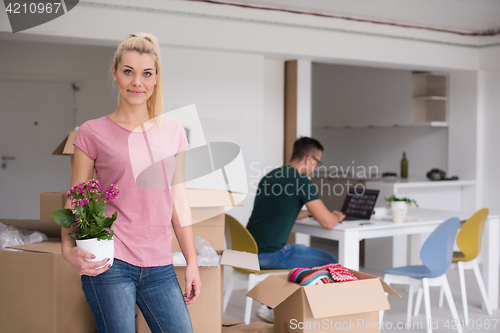 Image of young couple moving into a new home