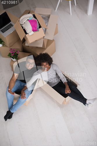 Image of African American couple  playing with packing material