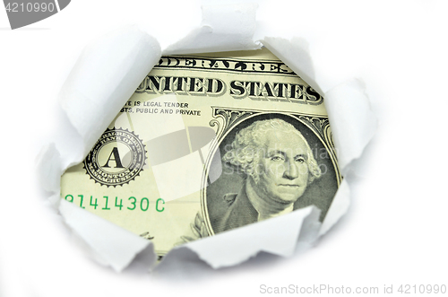 Image of US currency peeking through white paper.