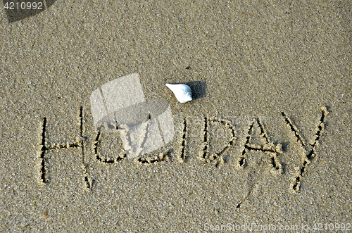 Image of Word holiday written in the sand 