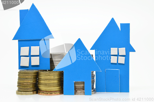 Image of House model and stacks of coins