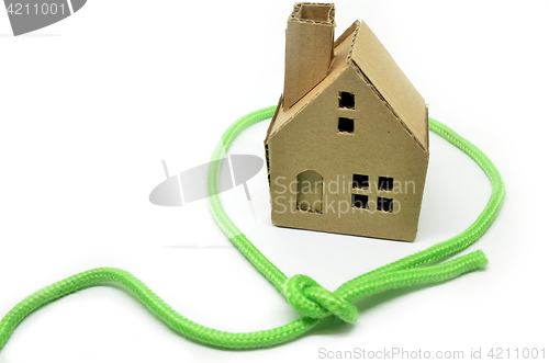 Image of Paper house surrounded by green rope