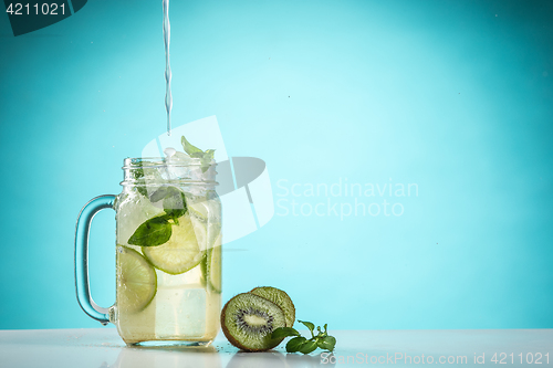 Image of The rose exotic cocktail and fruit on blue