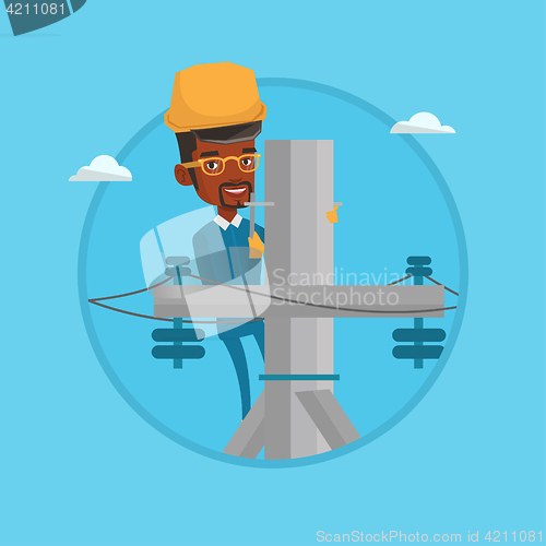 Image of Electrician working on electric power pole.