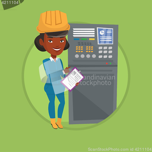 Image of Engineer standing near control panel.
