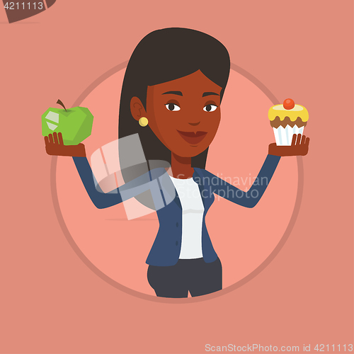 Image of Woman choosing between apple and cupcake.