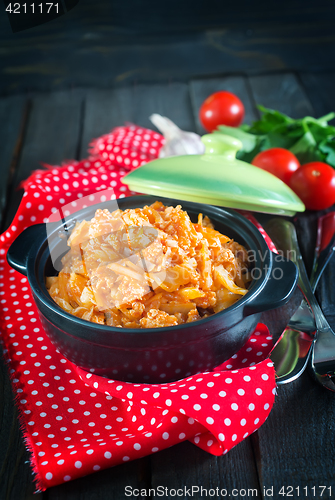 Image of fried cabbage in bowl and on a table