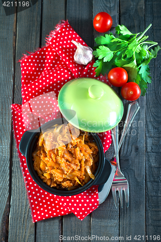 Image of fried cabbage in bowl and on a table