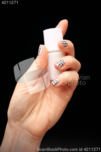 Image of Crazy manicure, black and white grid Woman&#39;s hand with fingernails painted in black and white checkered 