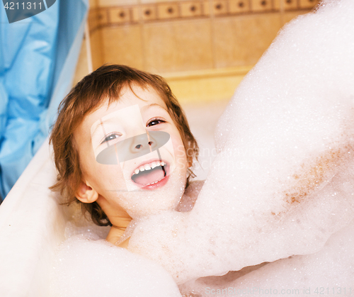 Image of little cute boy in bathroom with bubbles close up smiling, lifes