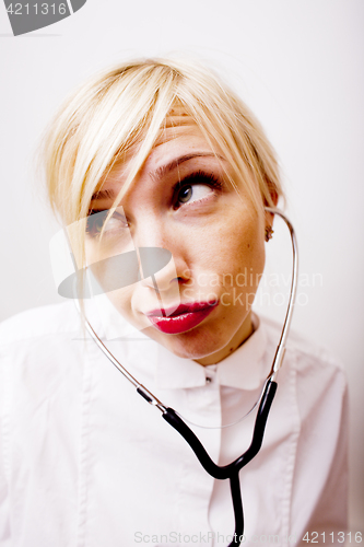 Image of young pretty woman doctor with stethoscope emotional posing, pointing in camers, lifestyle people concept 