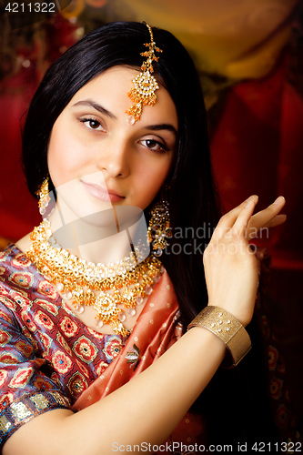 Image of beauty sweet real indian girl in sari smiling on black background