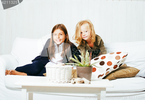 Image of two cute sisters at home playing, little girl in house interior 