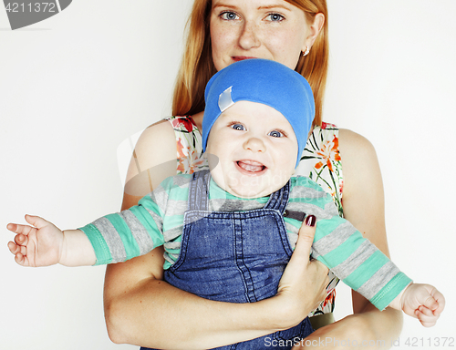 Image of young beauty mother with cute baby, red head happy modern family