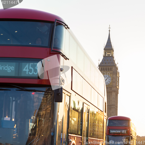 Image of Red double-decker buses passing on Westminster Bridge in London, UK.