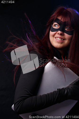 Image of Woman in mask holds laptop