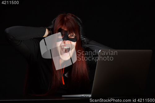 Image of Brunette hacker in black mask