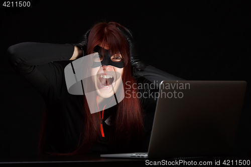 Image of Brunette hacker in black mask