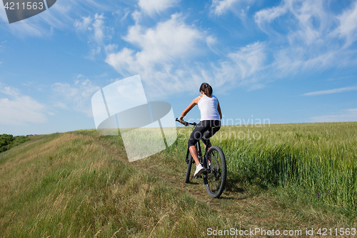 Image of Mountain biking happy sportive girl relax in meadows sunny countryside