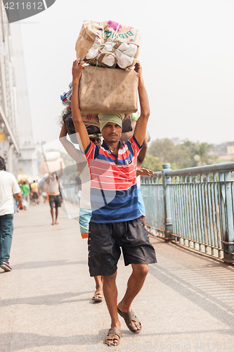 Image of Man carrying load on the Howrah Bridge